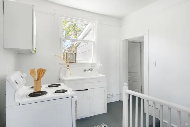 a view of washer and dryer with bathroom in the background