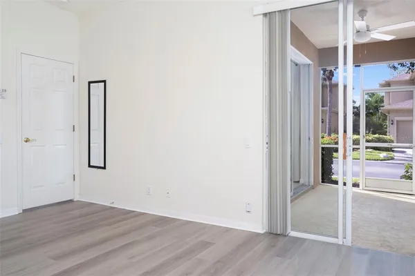 a view of empty room with wooden floor