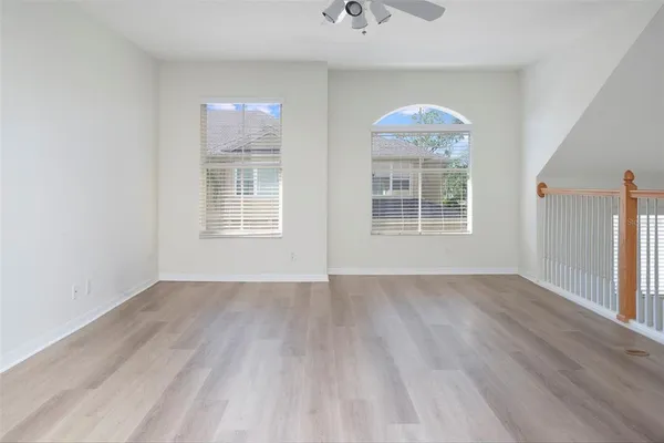 a view of a room with wooden floor