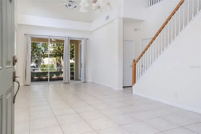 a view of a hallway with wooden floor and entryway