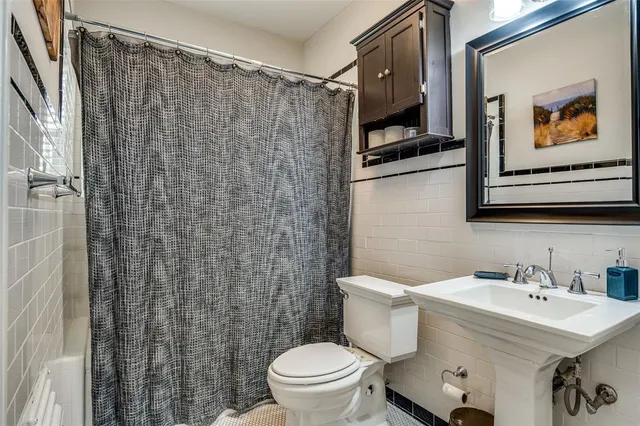 a bathroom with a sink toilet and mirror