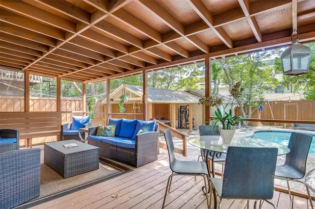a living room with patio furniture and a floor to ceiling window