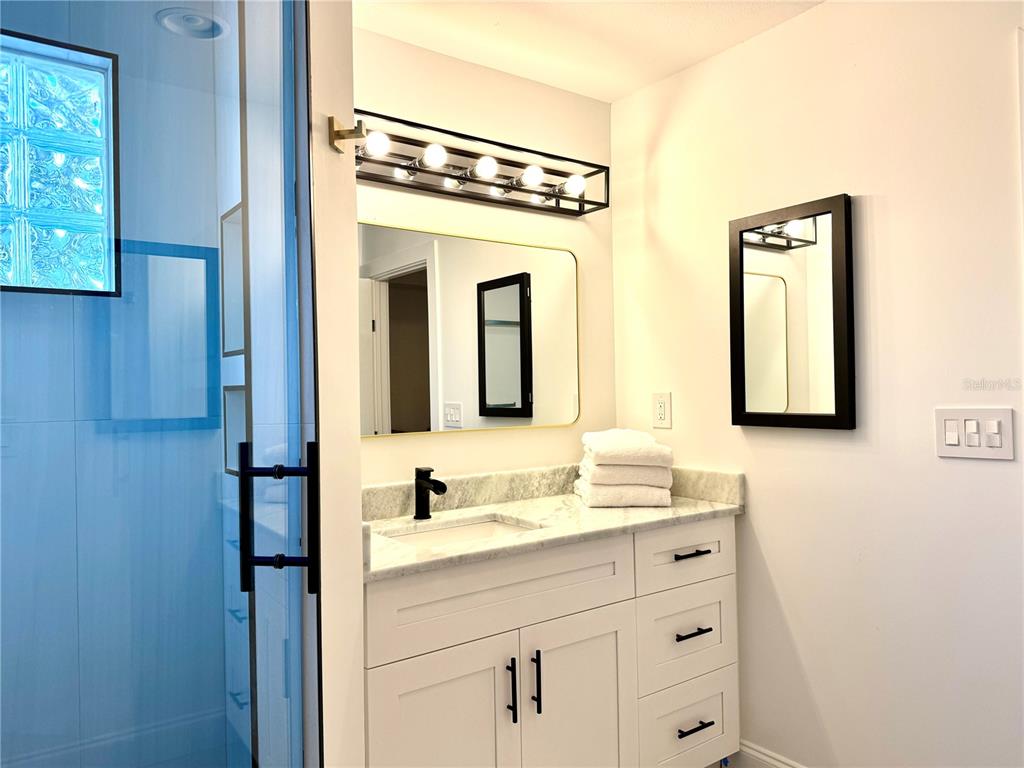 701 Broadway Street Longboat Key, FL 34228 - Photo 13 of 33 a bathroom with a sink and a mirror