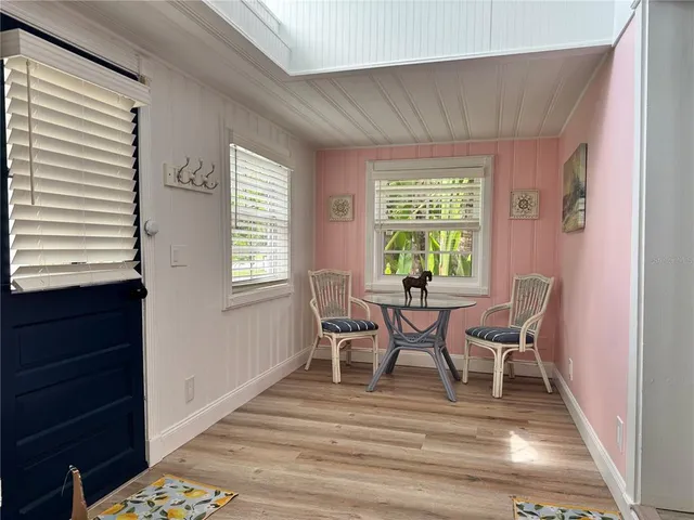 a dining room with furniture and wooden floor