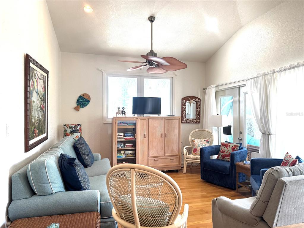 701 Broadway Street Longboat Key, FL 34228 - Photo 25 of 33 a living room with furniture a flat screen tv and a window