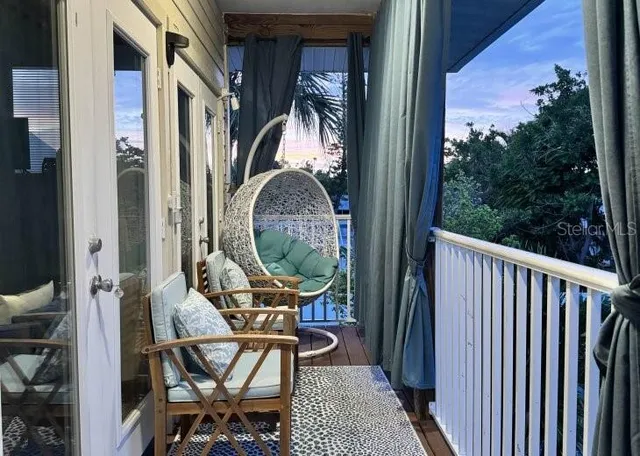 a view of a balcony with furniture