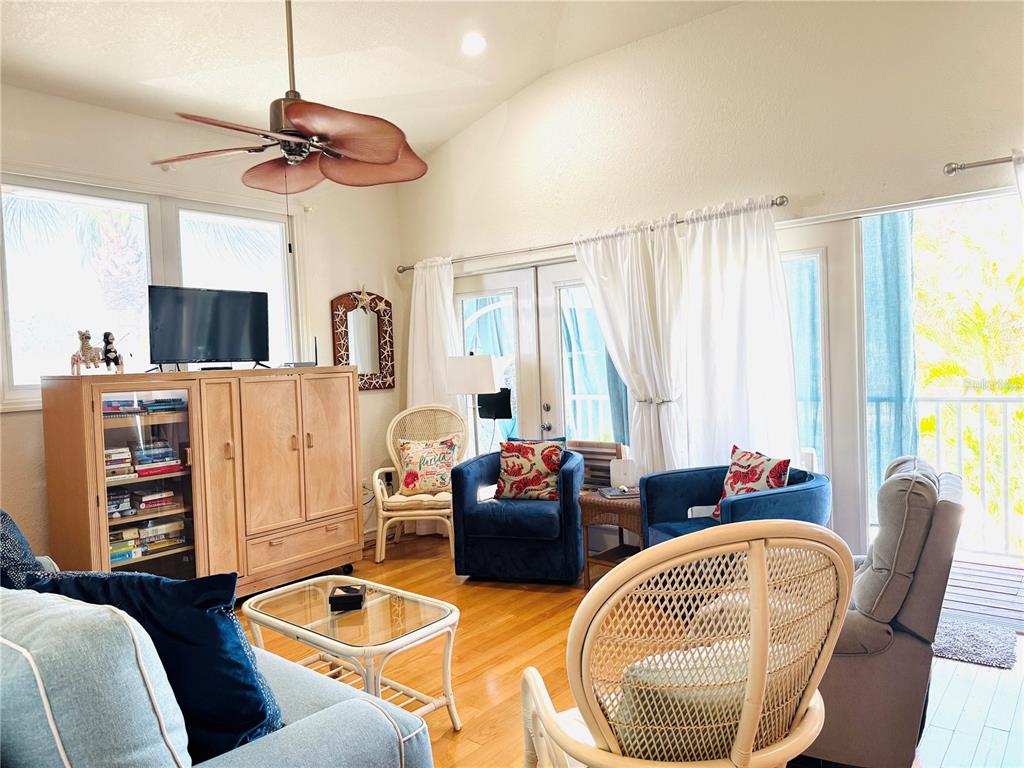 701 Broadway Street Longboat Key, FL 34228 - Photo 28 of 33 a living room with furniture a flat screen tv and a large window