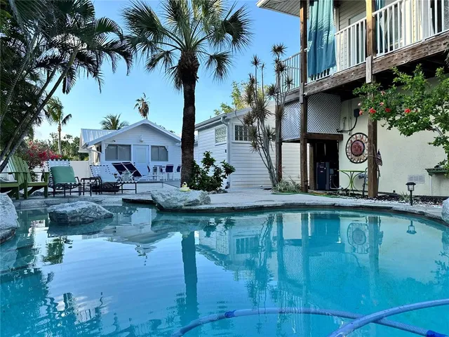 a swimming pool with outdoor seating and yard