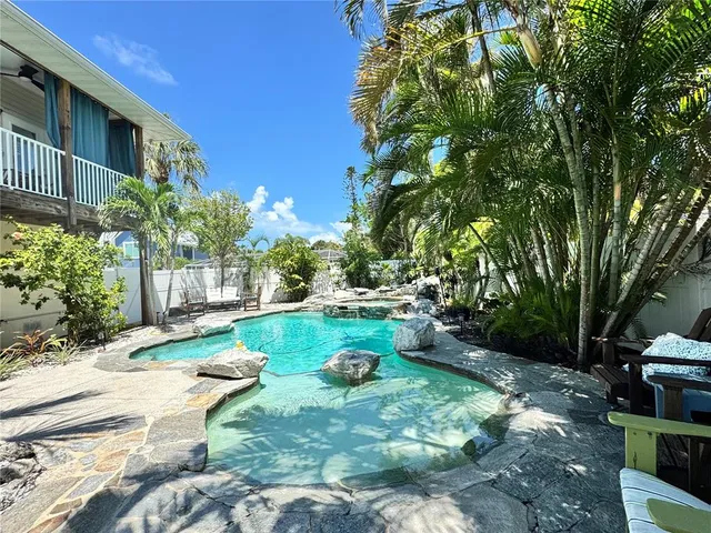 a view of backyard with swimming pool