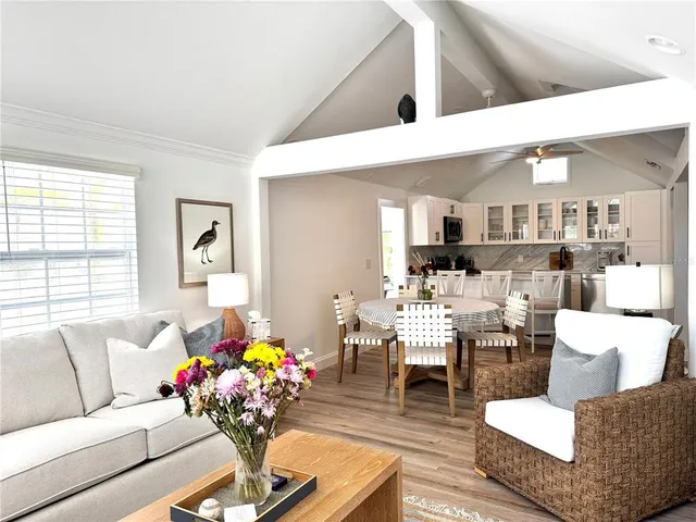 a living room with furniture and flowers