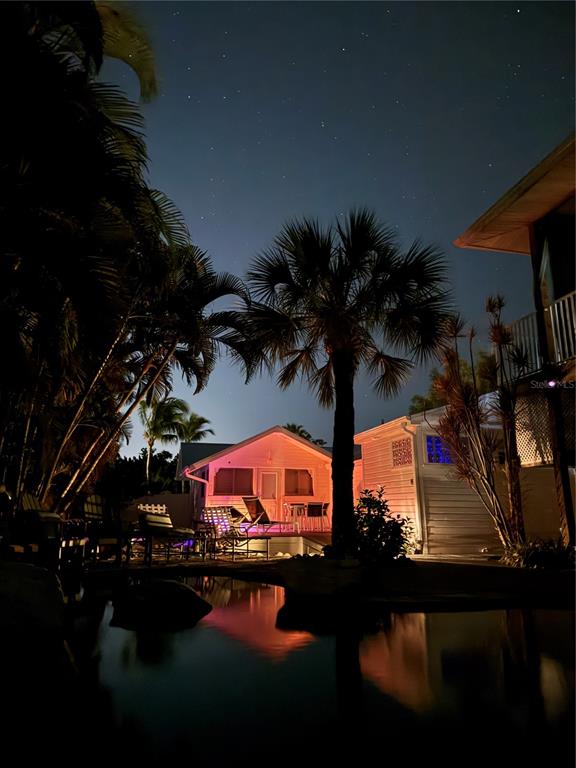 701 Broadway Street Longboat Key, FL 34228 - Photo 5 of 33 a view of swimming pool with table and chairs under an umbrella