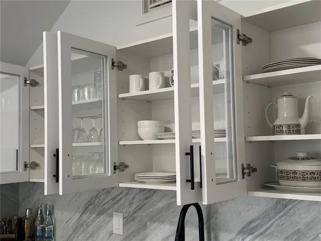 a room with a walk in closet and a wooden floor