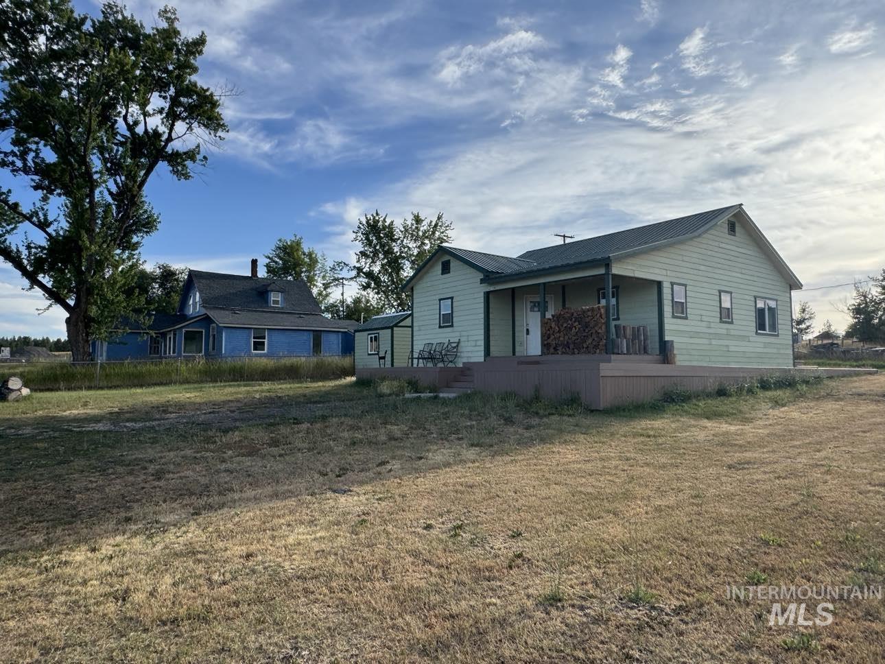 Back of property featuring covered porch