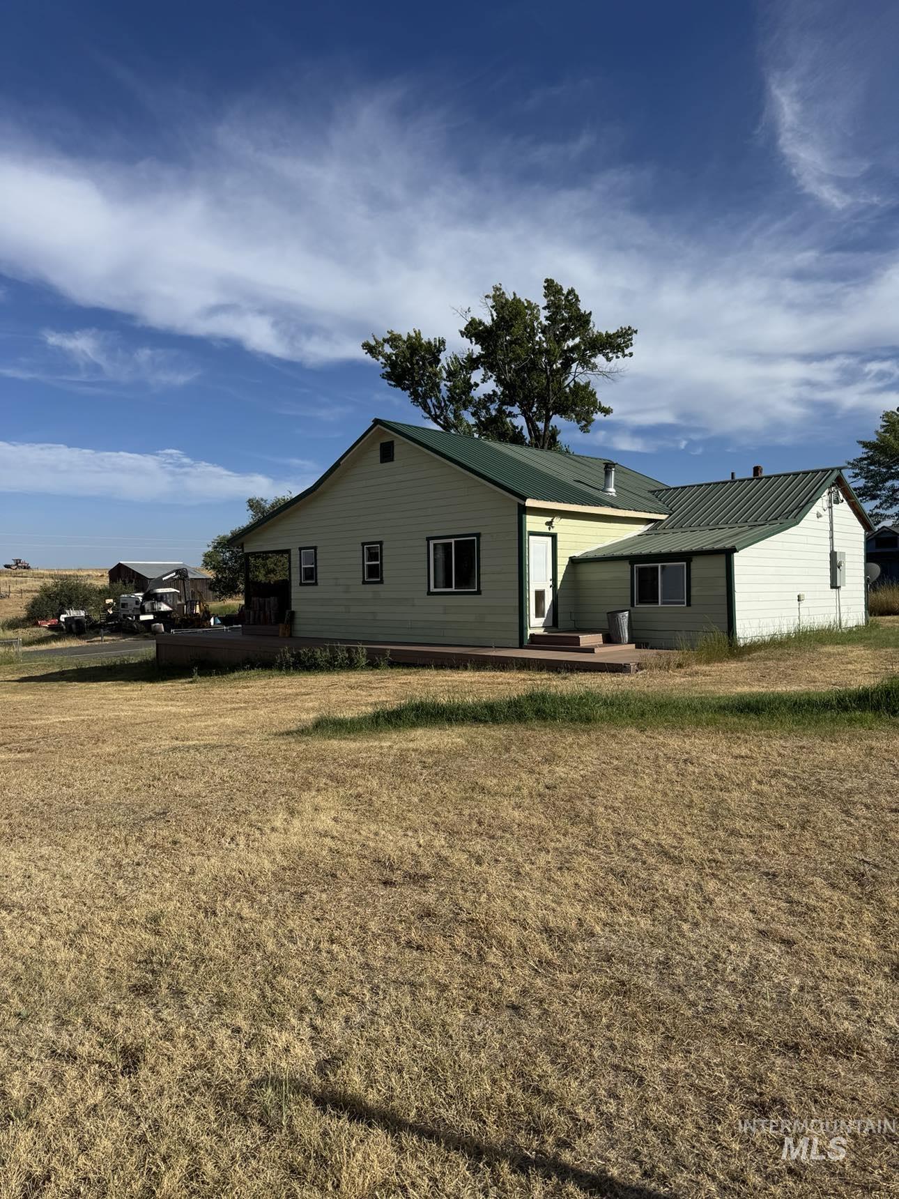 40336 Sr 129 Anatone, WA 99401 - Photo 2 of 29 1st House on the property from the backyard, featuring a metal roof and fully fenced yard.