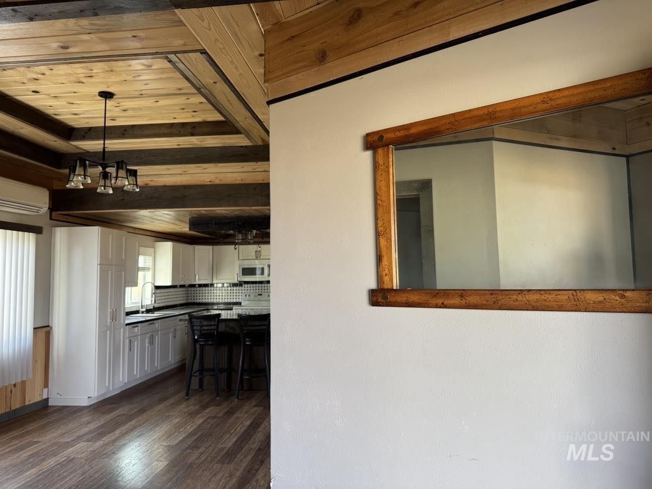 40336 Sr 129 Anatone, WA 99401 - Photo 3 of 29 Entry in the 1st House (Green House) with wooden ceiling, dark wood-style floors, white cabinetry, a wall mounted air conditioner, and a chandelier