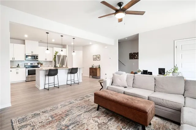 a living room with furniture and kitchen view