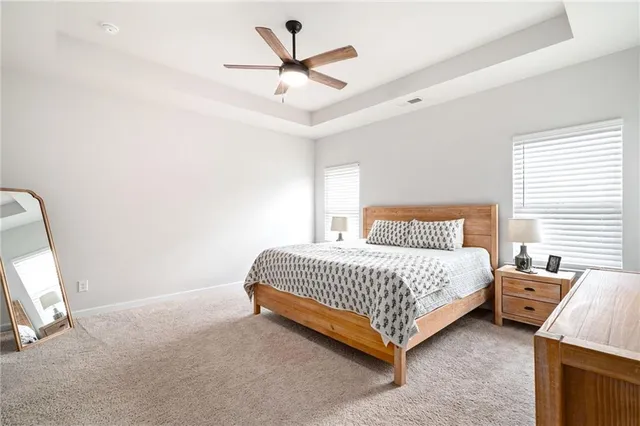 a bedroom with a bed and a ceiling fan