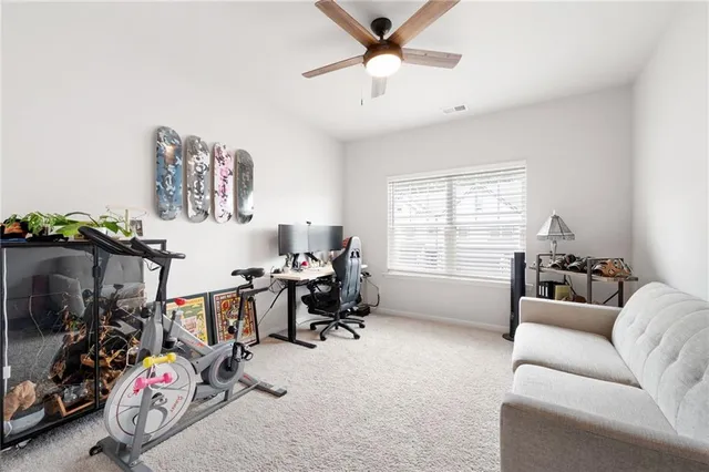 a view of a livingroom with workspace and a window