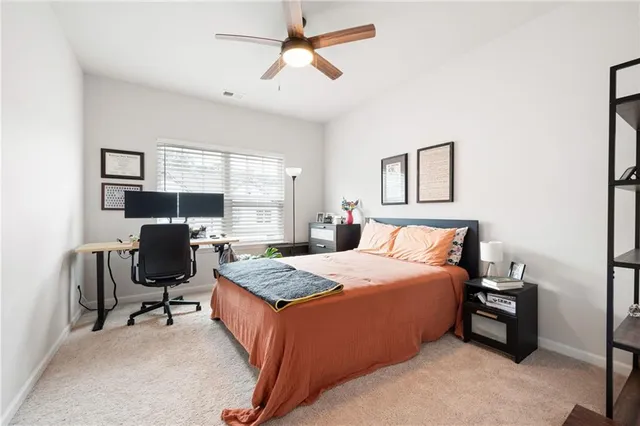 a bedroom with a bed workspace and a window