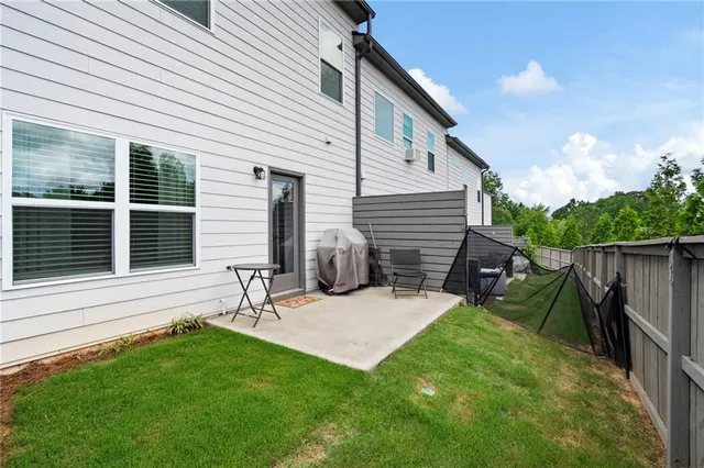a view of backyard with wooden stairs and a fence