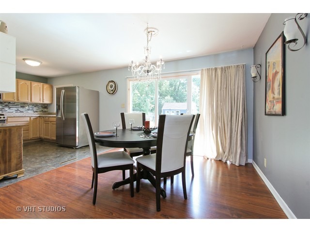 115 East Oltendorf Road Streamwood, IL 60107 - Photo 4 of 10 a view of a dining room with furniture window and wooden floor