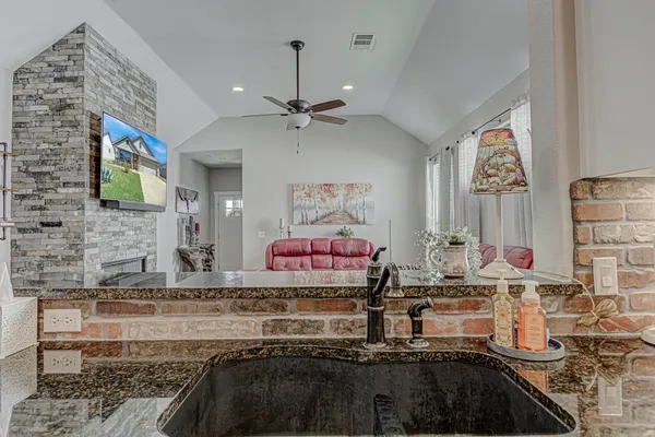 a kitchen with stainless steel appliances granite countertop a stove and a sink