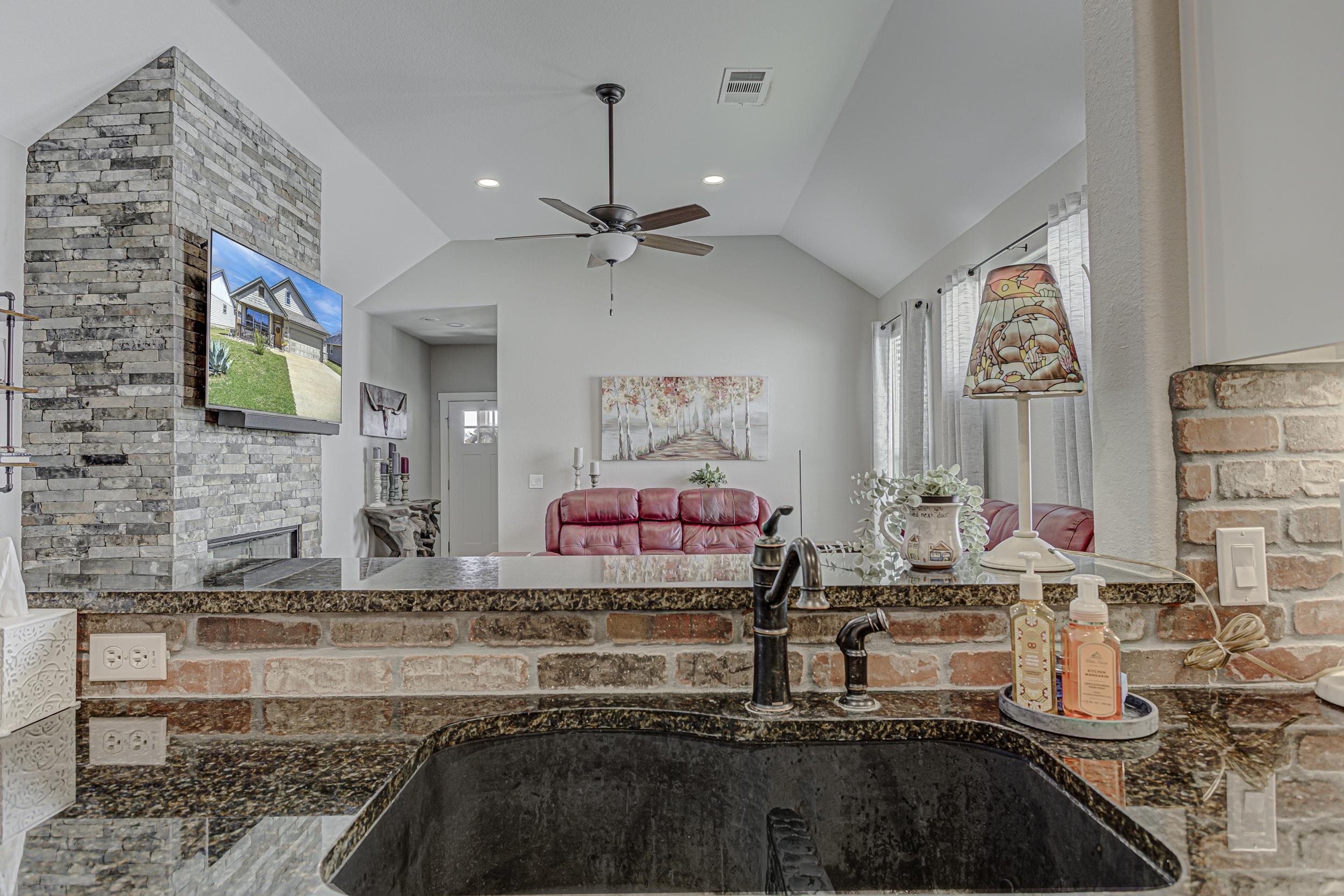 433 Dove Trail Bertram, TX 78605 - Photo 12 of 30 a kitchen with stainless steel appliances granite countertop a stove and a sink