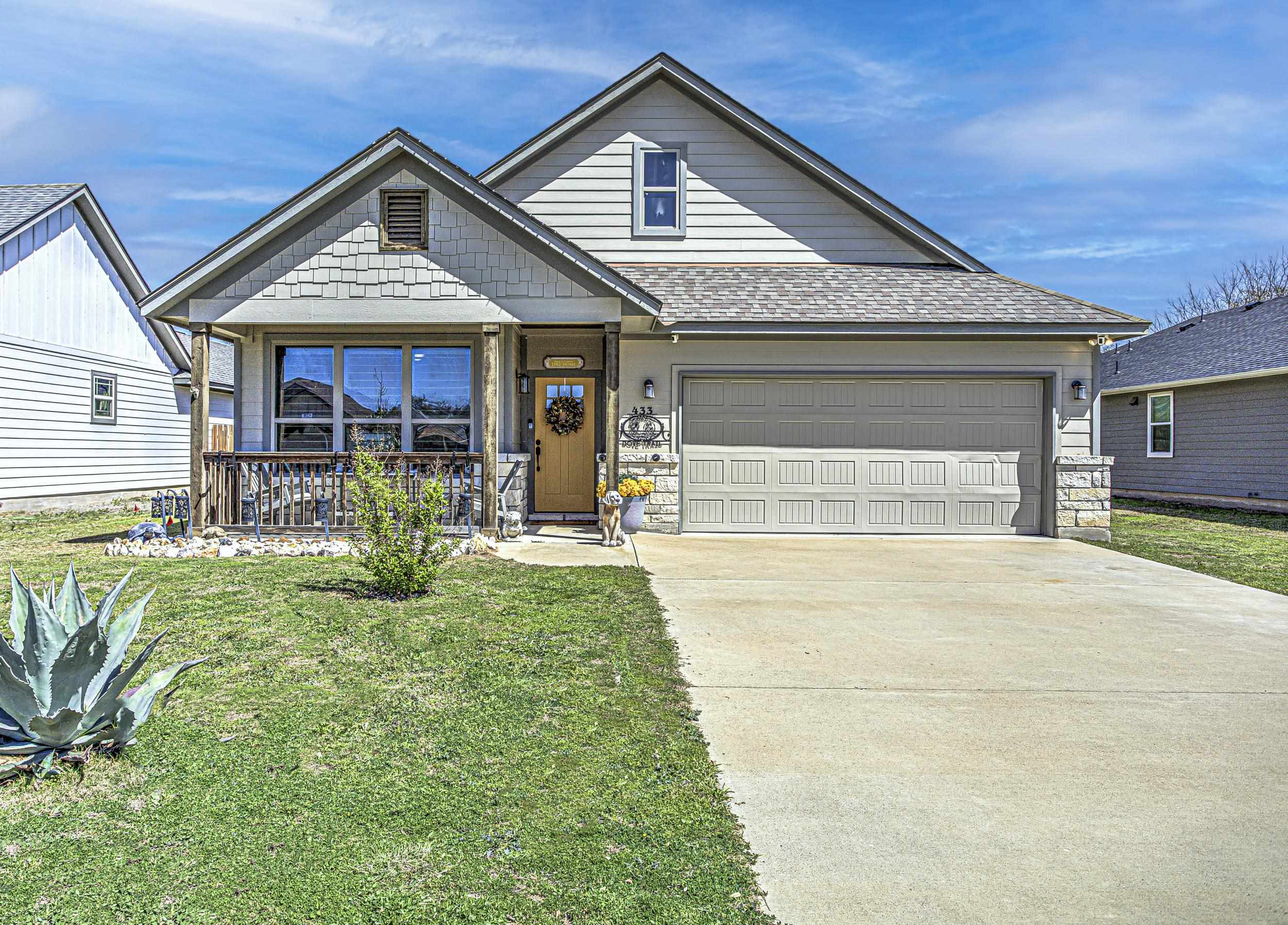 433 Dove Trail Bertram, TX 78605 - Photo 2 of 30 a front view of a house with a yard outdoor seating and garage