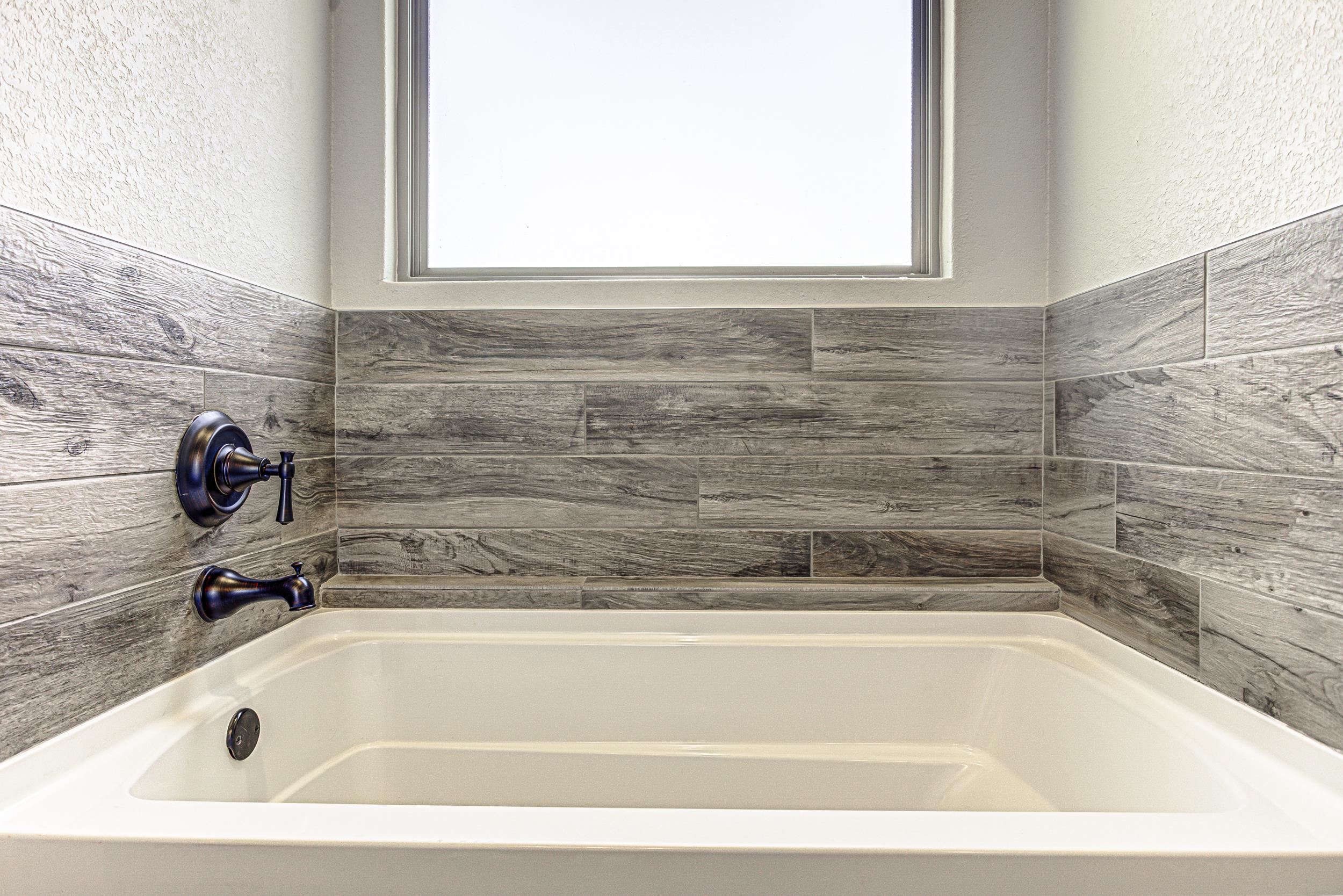 433 Dove Trail Bertram, TX 78605 - Photo 24 of 30 a bathroom with a bathtub