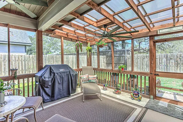 a balcony with furniture and wooden floor