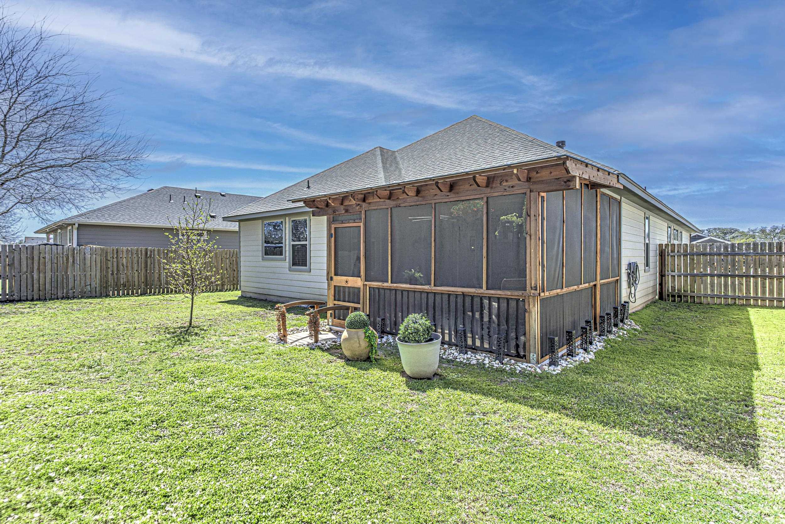 433 Dove Trail Bertram, TX 78605 - Photo 28 of 30 a view of a house with backyard and wooden fence