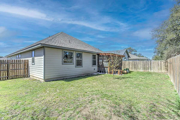 a backyard of a house with table and chairs