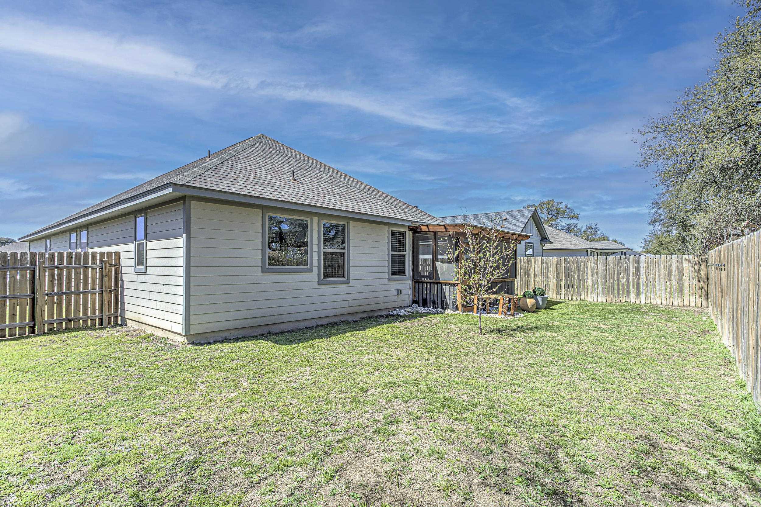 433 Dove Trail Bertram, TX 78605 - Photo 30 of 30 a backyard of a house with table and chairs