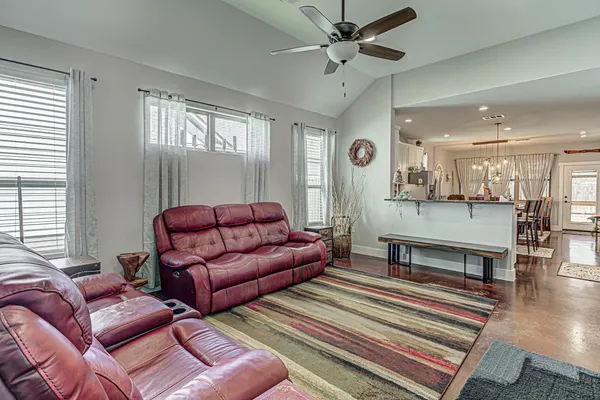 a living room with furniture and wooden floor