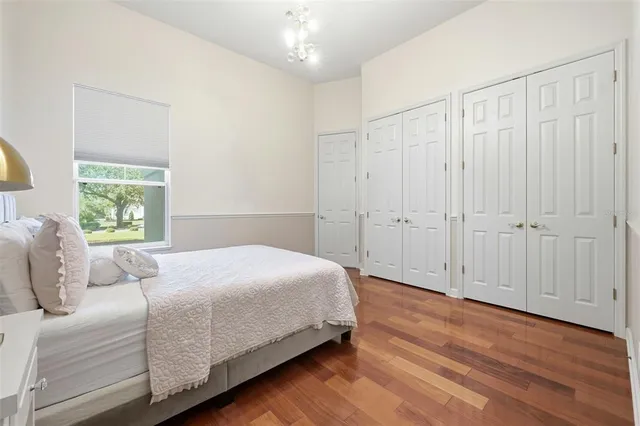 a bedroom with a bed and a potted plant