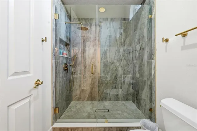 a kitchen with a refrigerator a stove a sink dishwasher and a dining table with wooden floor