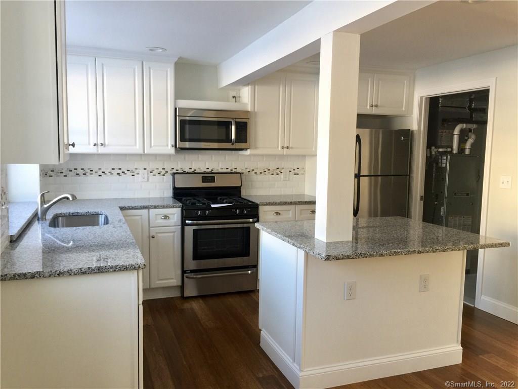 65 Muir Terrace Southington, CT 06489 - Photo 1 of 1 a kitchen with granite countertop a sink stove and refrigerator