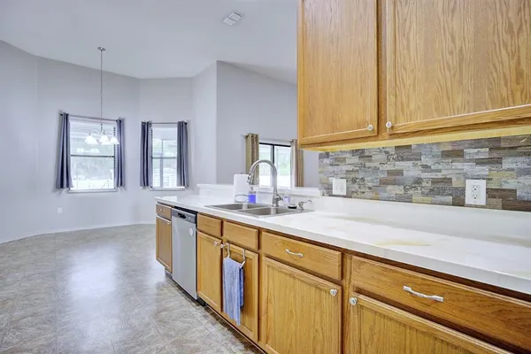 a kitchen with sink and cabinets