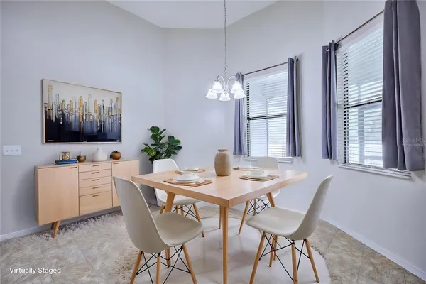 a dining room with furniture a flat screen tv and a window