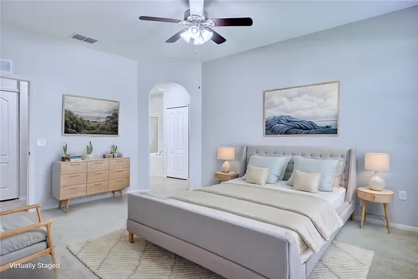 a spacious bedroom with a bed and a couch