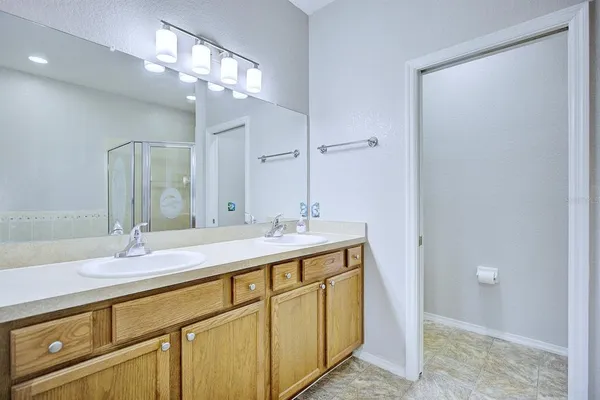 a bathroom with a double vanity sink and a mirror