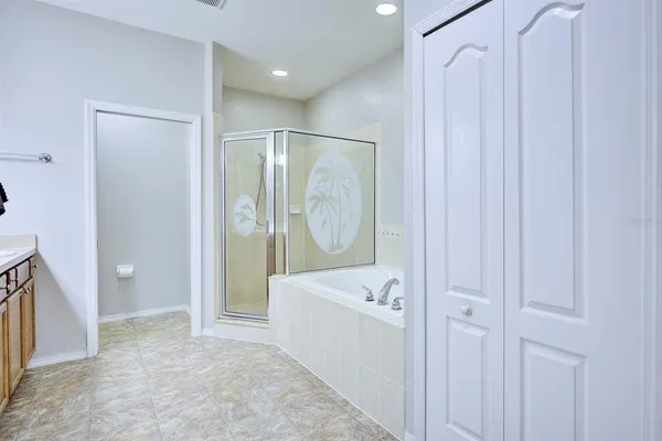 a bathroom with a tub sink and mirror