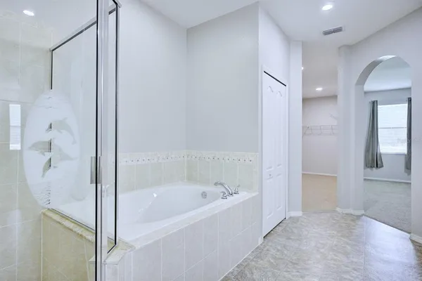 a bathroom with a bathtub and shower