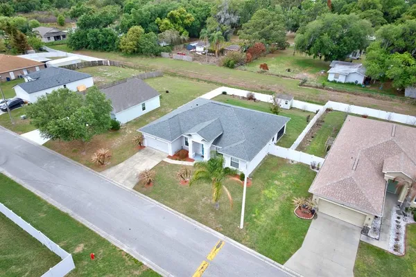 an aerial view of a house with garden space and street view