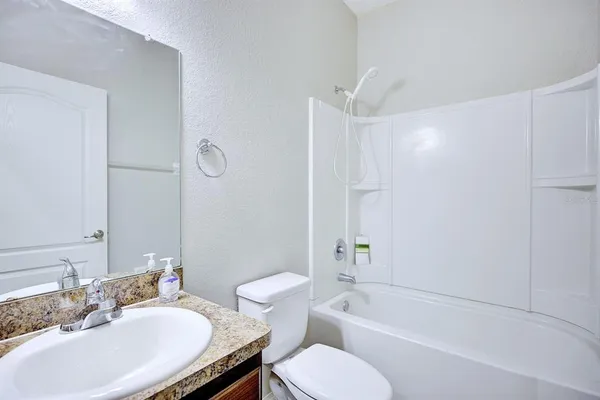 a bathroom with a sink toilet and bathtub