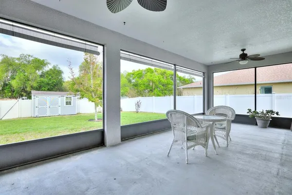 a view of a porch with furniture and a yard