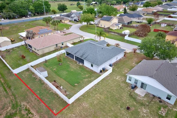 an aerial view of residential houses with outdoor space and street view