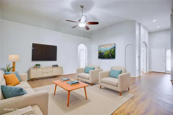 a living room with furniture and a flat screen tv