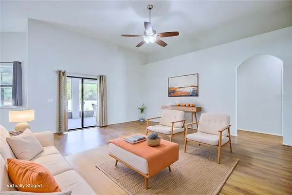 a living room with furniture and wooden floor