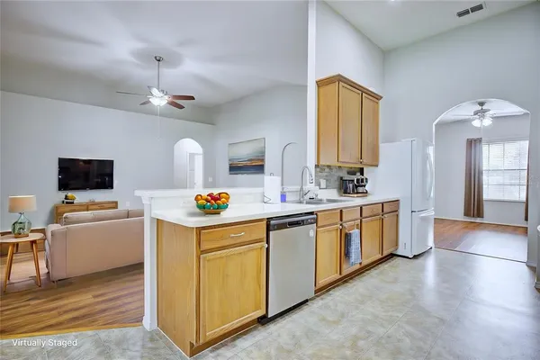 a kitchen that has a lot of cabinets and wooden floor